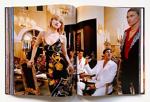 Open book showing a scene with a woman in a black dress and men in formal attire in an elegant room.