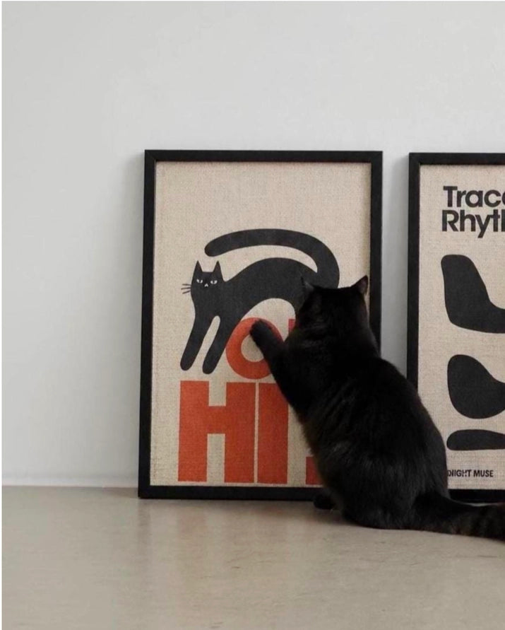 framed wall scratcher with oh hi text and black cat