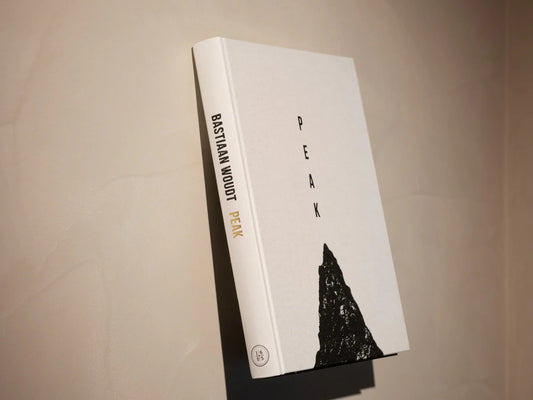 Book titled 'Peak' by Bastian Wood on a beige background