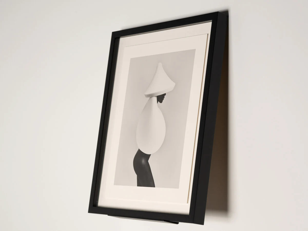 Framed black and white abstract art on a white wall
