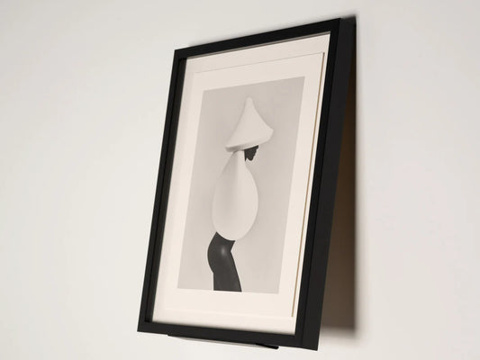 Framed black and white abstract art on a white wall