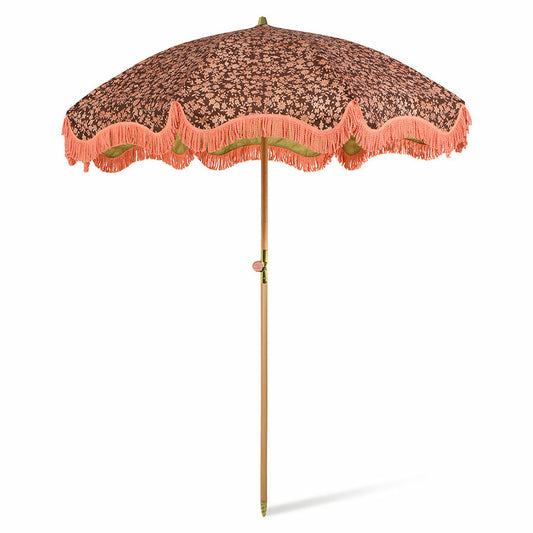 retro style beach umbrella with brown and orange floral  fabric and orange fringes
