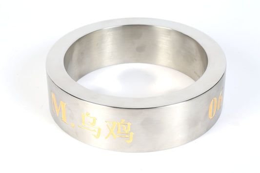 round steel sculpture with golden engraving