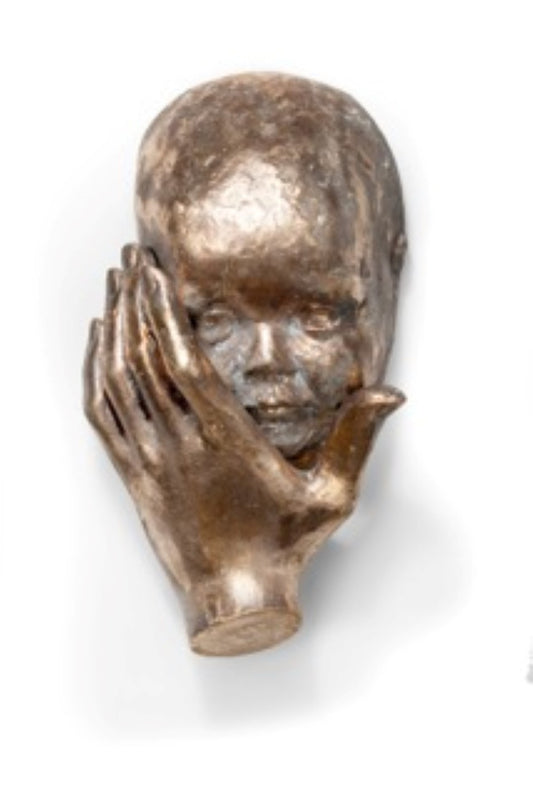 3d sculpture in bronze of hand that holds the prescious face of a baby