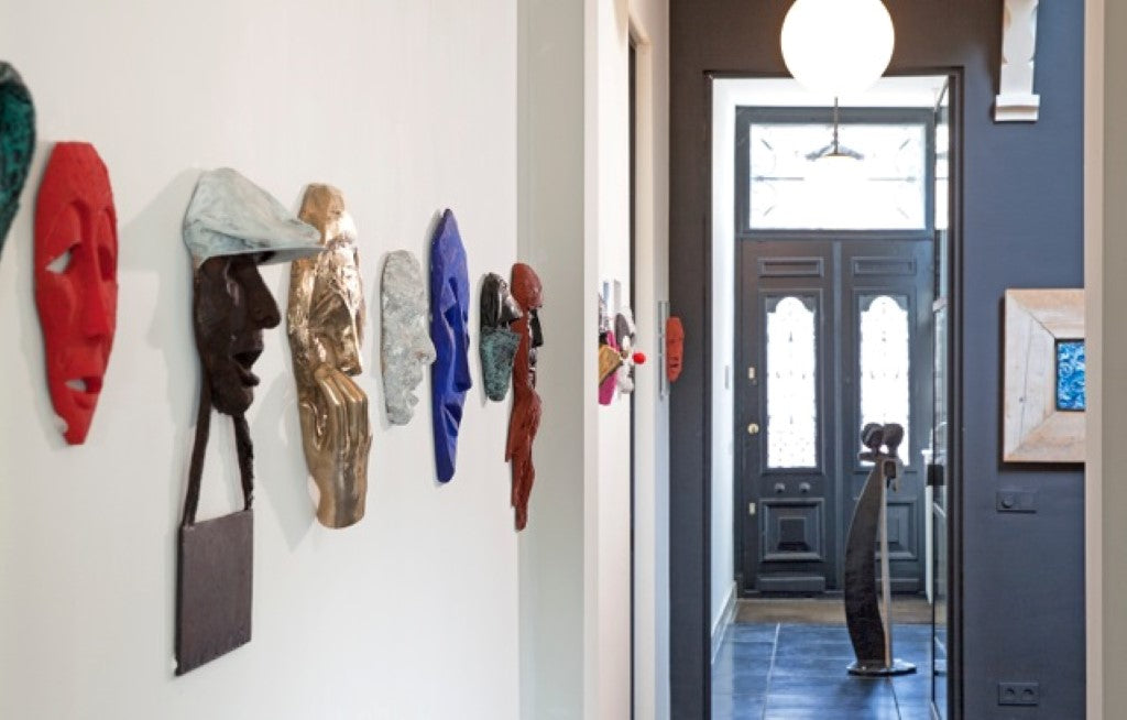 house of art collector with row of 3d bronze sculptures