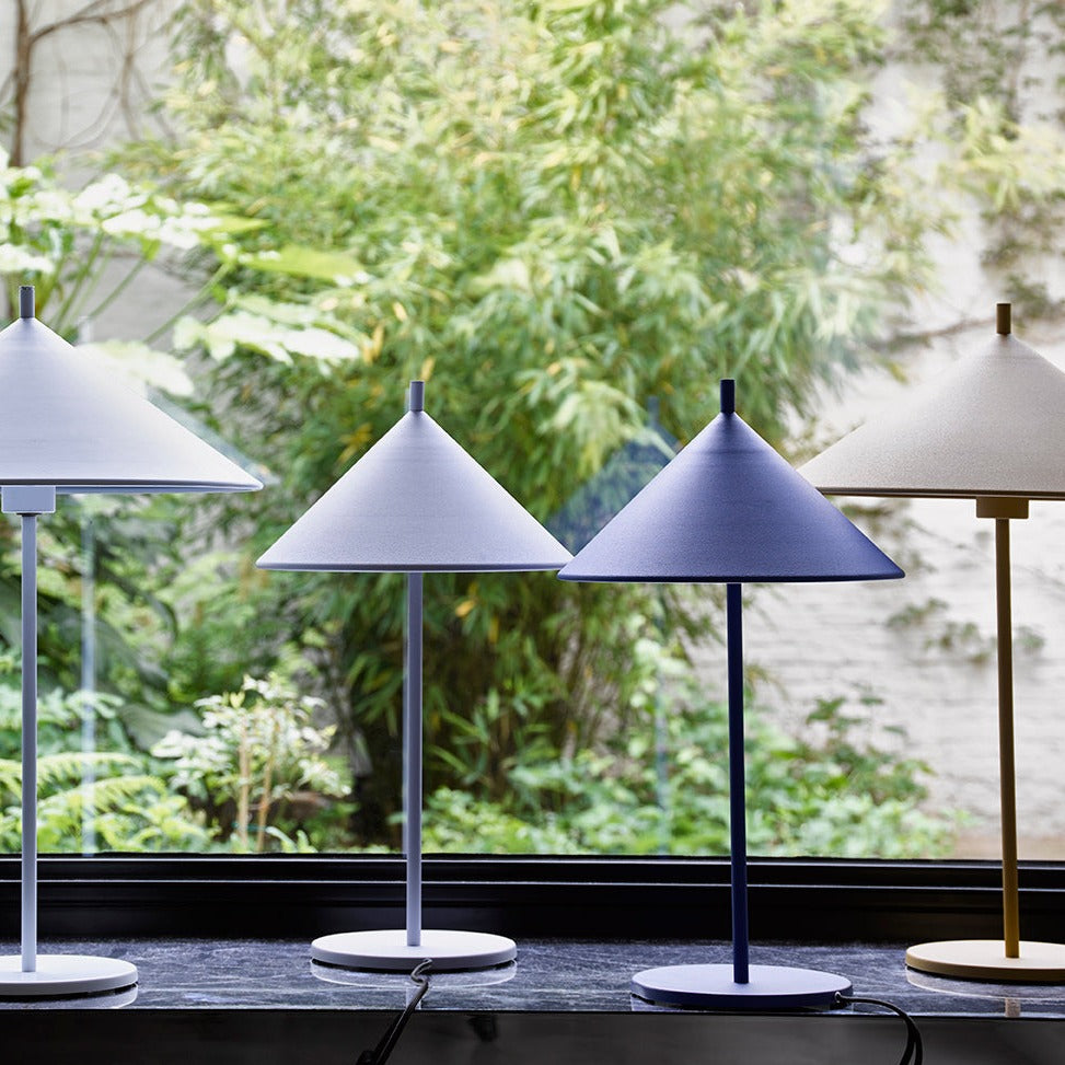 metal table lamps with triangle shaped shades in a window placement