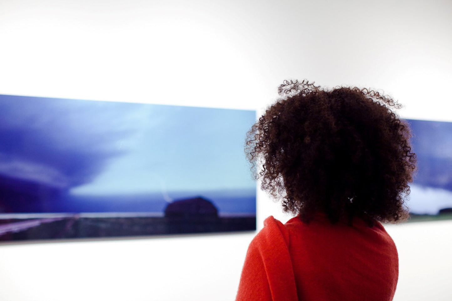 picture of woman looking at a supercell photo at gallery exhibition