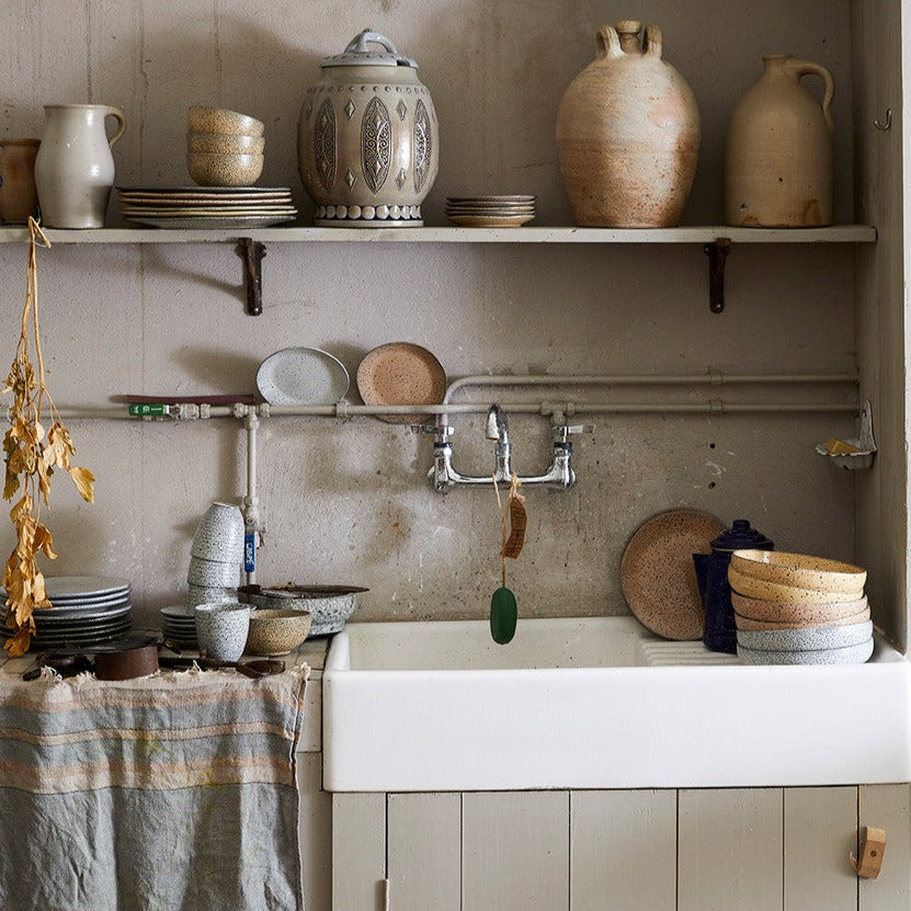 candinavian farmhouse style kitchen with gradient ceramics and antique jars