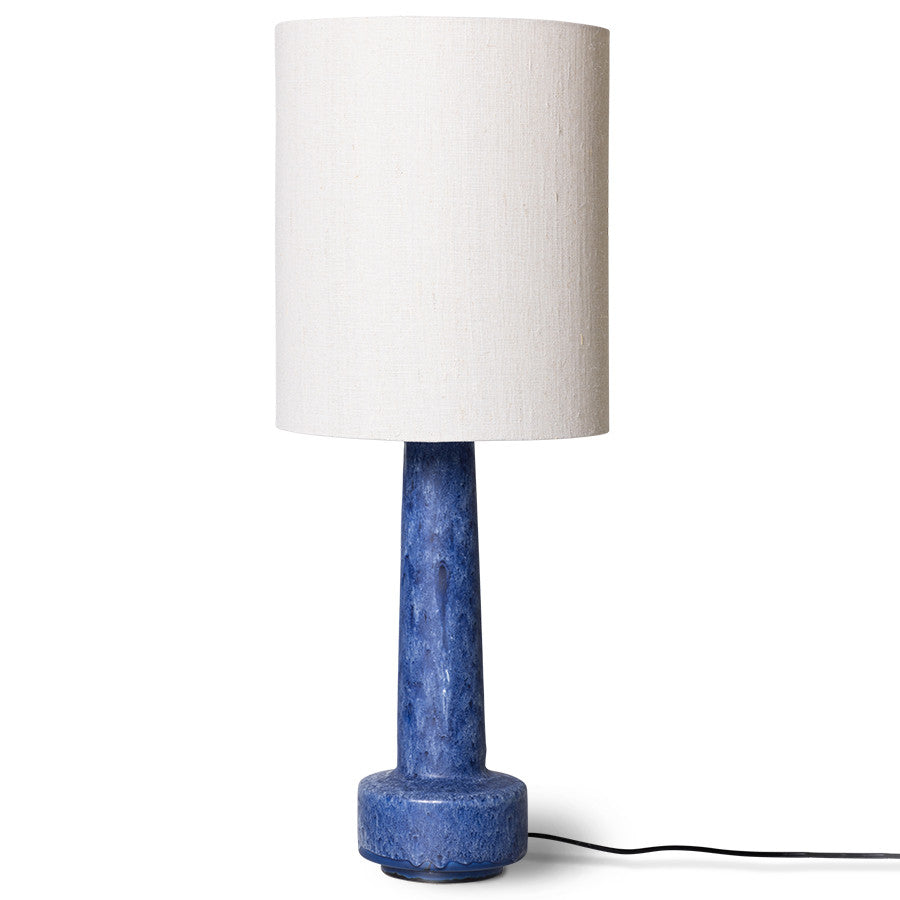 table lamp with blue stoneware base and white linen shade