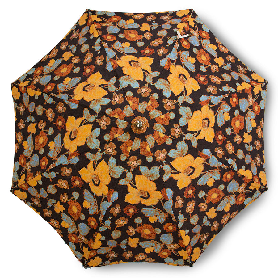 top view of retro style parasol with wooden pole floral design and blue fringes