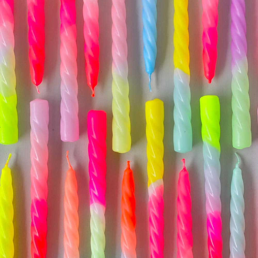 neon colored dipped dyed twisted candle sticks in green yellow blue pink and orange colors