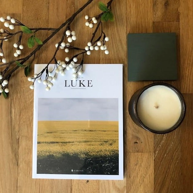 The Gospel of Luke with beautiful photo cover and a candle