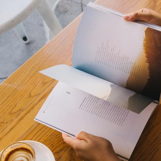 cup of appucinno and Bible book with beautiful illustrations and photography