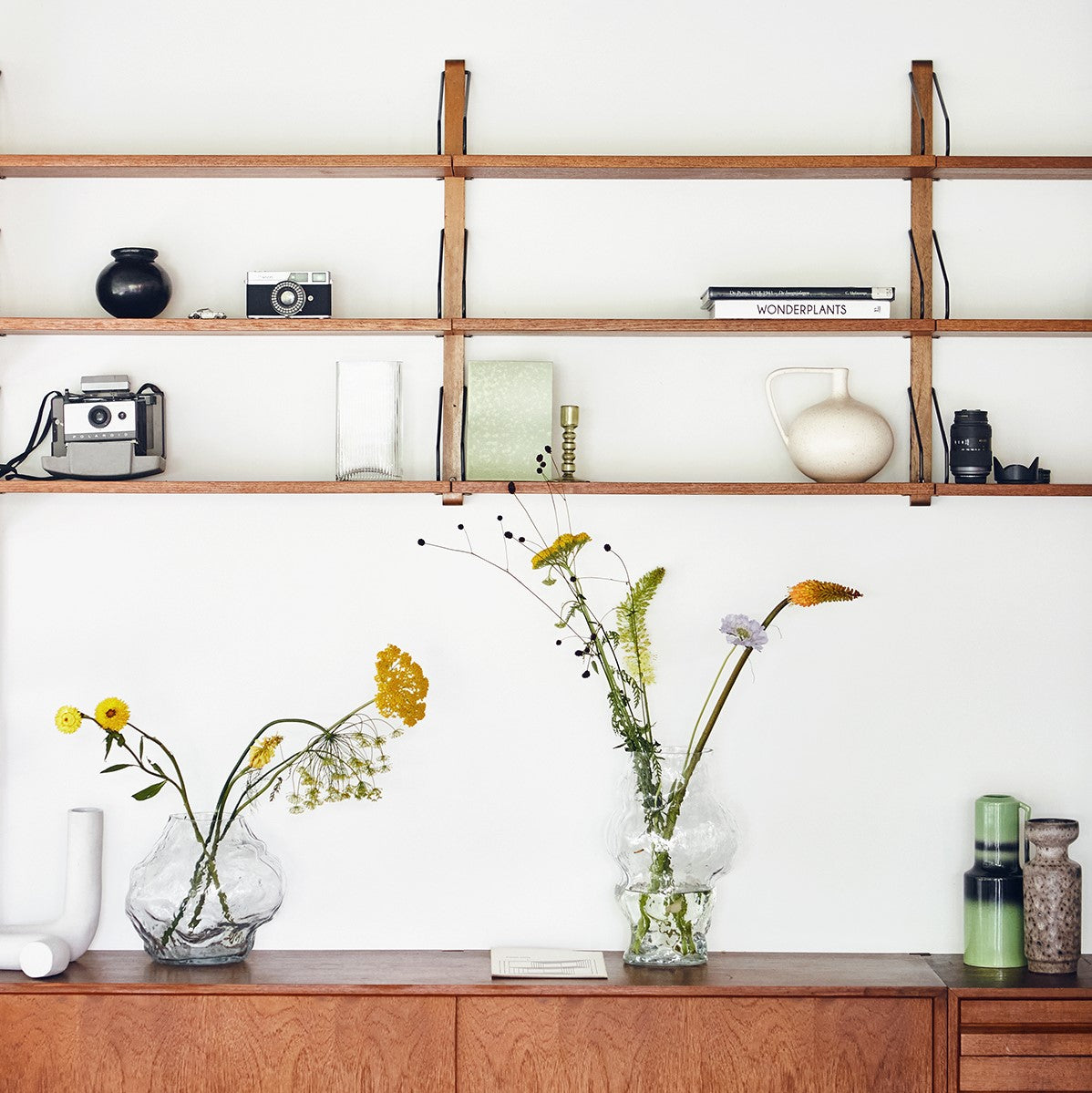 open shelving with art objects and flowers