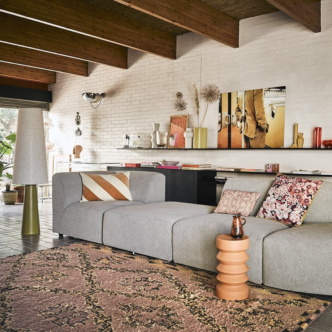 midcentury modern living room with stoneware accent table in terracotta color