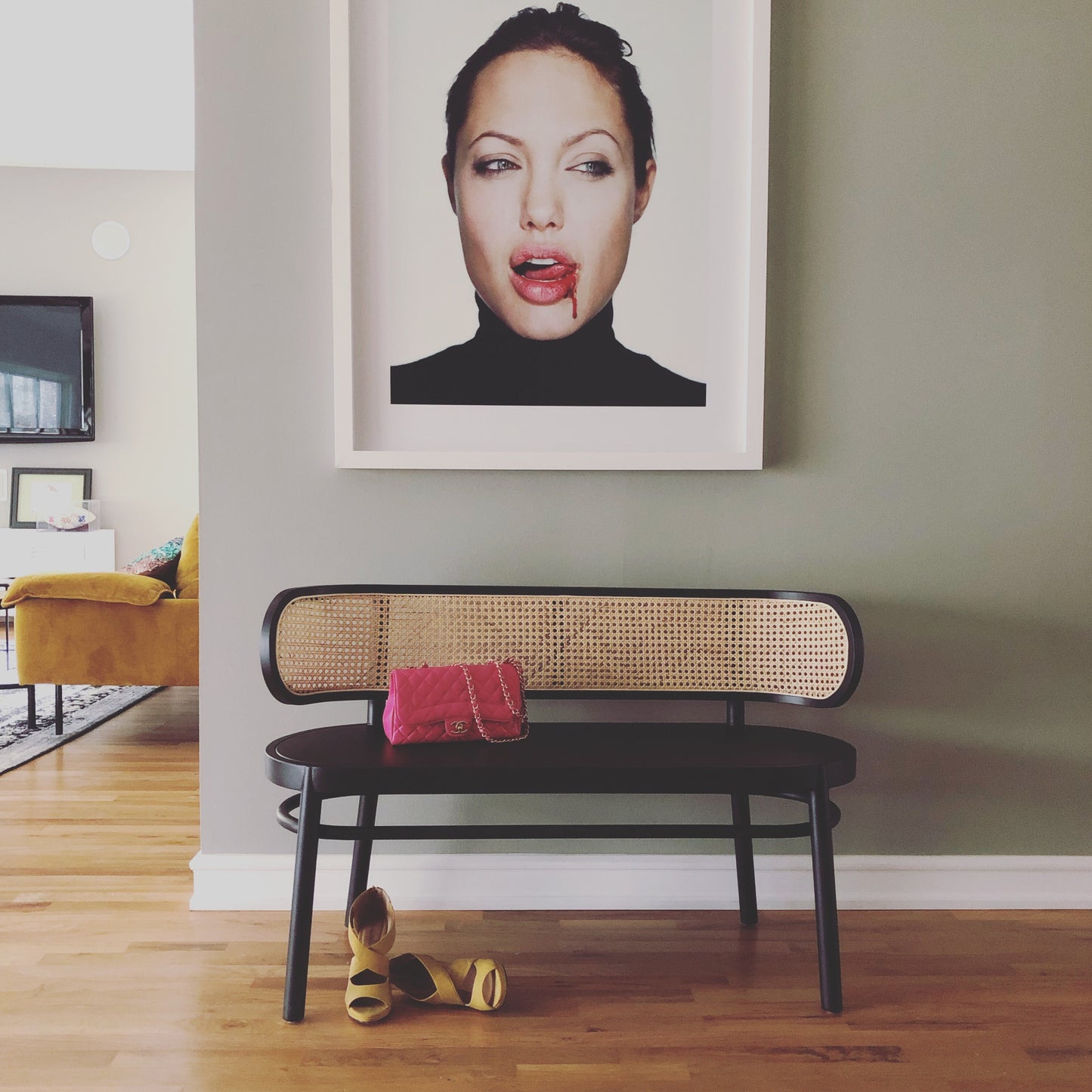 angelina jolie portrait with black hk living usa cane webbing bench and pink chanel bag